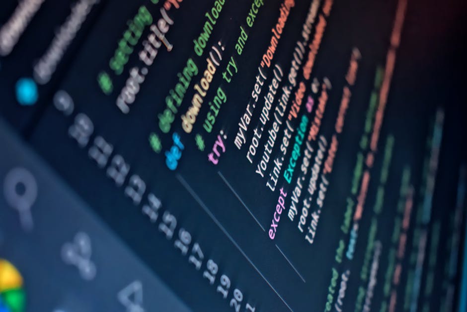 Close-up view of a computer screen displaying colorful lines of code with syntax highlighting in various shades of green, pink, orange, blue, and purple against a dark background. The text includes pr